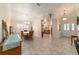 Charming dining room with tile flooring, chandelier, and seamless flow into the kitchen at 17959 Se 89Th Natchez Ave, The Villages, FL 32162