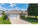 Charming single-story home with a two-car garage, well-maintained lawn and an inviting driveway at 17959 Se 89Th Natchez Ave, The Villages, FL 32162