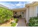 Inviting front porch with charming potted plants and seating, creating a cozy entrance at 17959 Se 89Th Natchez Ave, The Villages, FL 32162