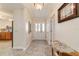 Bright hallway with a decorative table and seamless transition to the kitchen area at 17959 Se 89Th Natchez Ave, The Villages, FL 32162
