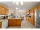 Bright kitchen with tile flooring, oak cabinets, and a sunlit breakfast nook with bay windows at 17959 Se 89Th Natchez Ave, The Villages, FL 32162
