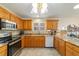 Bright eat-in kitchen featuring wooden cabinets, stainless appliances and granite counters at 17959 Se 89Th Natchez Ave, The Villages, FL 32162