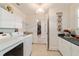 Bright laundry room with modern appliances and ample storage space, offering convenience and functionality at 17959 Se 89Th Natchez Ave, The Villages, FL 32162