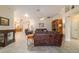 Inviting living room with tile flooring, neutral paint, and natural light, offering a comfortable living space at 17959 Se 89Th Natchez Ave, The Villages, FL 32162