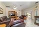 Cozy living room with leather furniture, tile floors and a sliding door to the lanai at 17959 Se 89Th Natchez Ave, The Villages, FL 32162