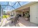 Screened-in patio with outdoor seating, table, ceiling fan, and access to the backyard at 17959 Se 89Th Natchez Ave, The Villages, FL 32162