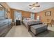 Comfortable bedroom featuring a king-sized bed, ceiling fan, and soft lighting at 1902 Se 37Th Court Cir, Ocala, FL 34471
