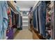 Walk-in closet featuring custom shelving, ample storage space, and tile floors at 1902 Se 37Th Court Cir, Ocala, FL 34471