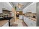 Well-lit kitchen with modern appliances, neutral countertops, and cabinetry with easy access to the dining area at 1902 Se 37Th Court Cir, Ocala, FL 34471