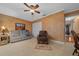 Relaxing living room with a sofa, arm chair, side table, accent wall, and neutral tile flooring at 1902 Se 37Th Court Cir, Ocala, FL 34471