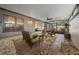 Enclosed patio featuring multiple seating areas, neutral siding, and decorative rock landscaping at 1902 Se 37Th Court Cir, Ocala, FL 34471