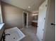 Spa-like bathroom featuring a standalone tub, modern fixtures, and tiled floors at 1972 Nw 85 Loop, Ocala, FL 34475