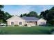 New home exterior with neutral siding, manicured lawn, and lush landscaping at 1972 Nw 85 Loop, Ocala, FL 34475