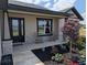 Inviting front porch with rocking chairs, stone accents, and professionally landscaped garden at 1972 Nw 85 Loop, Ocala, FL 34475