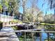 Community wooden dock with boat slips on a tranquil waterfront setting at 20800 River Dr # A17, Dunnellon, FL 34431