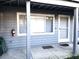 Exterior view of the condominium showing the front door and adjacent window at 20800 River Dr # A17, Dunnellon, FL 34431