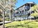 Multi-level condominium building near the water features multiple balconies and lush landscaping at 20800 River Dr # A17, Dunnellon, FL 34431