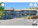 Three-story condominium building with balconies and ample parking on a sunny day at 20800 River Dr # A17, Dunnellon, FL 34431