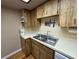 Functional kitchen features wood cabinetry, stainless steel sink, and essential appliances, perfect for cooking at 20800 River Dr # A17, Dunnellon, FL 34431