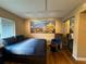 Bright and well-lit living area with a bed, recliner, and mirrored closet at 20800 River Dr # A17, Dunnellon, FL 34431
