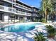 Community pool with lounge chairs and well-maintained landscaping at 20800 River Dr # A17, Dunnellon, FL 34431