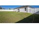 Fenced backyard has a well-maintained lawn and a patio set for outdoor enjoyment at 3352 Sw 127Th Lane Rd, Ocala, FL 34473