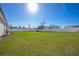Spacious fenced backyard with a green lawn and an outdoor seating area perfect for relaxing at 3352 Sw 127Th Lane Rd, Ocala, FL 34473