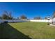 Wide-open backyard featuring lush green grass, complete with a full fence, and patio area at 3352 Sw 127Th Lane Rd, Ocala, FL 34473