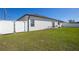 The home features a fenced backyard with green grass and an outdoor patio set at 3352 Sw 127Th Lane Rd, Ocala, FL 34473