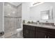 Bathroom with double vanity, granite counters, and a glass-enclosed walk-in shower at 3352 Sw 127Th Lane Rd, Ocala, FL 34473
