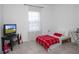 Cozy bedroom with a simple decor, featuring tile floors and natural light from the window at 3352 Sw 127Th Lane Rd, Ocala, FL 34473