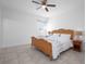 Serene bedroom with a ceiling fan, neutral paint, and tile floors at 3352 Sw 127Th Lane Rd, Ocala, FL 34473