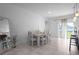 Bright dining area featuring a large white wood table and access to the back yard at 3352 Sw 127Th Lane Rd, Ocala, FL 34473