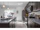 Modern kitchen featuring a large sink, granite counters, and stainless steel appliances at 3352 Sw 127Th Lane Rd, Ocala, FL 34473
