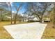 Long driveway leading to a charming home and screened in porch, surrounded by lush mature trees at 3621 Sw 52Nd Ter, Ocala, FL 34474