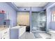 Spa bathroom featuring a soaking tub, glass-enclosed shower, and blue walls at 3621 Sw 52Nd Ter, Ocala, FL 34474