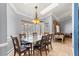 Bright dining room with marble table, stylish light fixture, and backyard pool view at 3621 Sw 52Nd Ter, Ocala, FL 34474