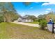 Long driveway leading to a white home surrounded by mature trees, offering privacy and ample parking at 3621 Sw 52Nd Ter, Ocala, FL 34474