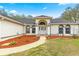 Close up of front entrance showcasing double white doors, arched transom window, and manicured landscaping at 3621 Sw 52Nd Ter, Ocala, FL 34474