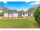 Charming single-story home featuring a white exterior, arched windows, and a well-maintained front yard with a landscaped pathway at 3621 Sw 52Nd Ter, Ocala, FL 34474