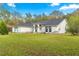 Well-maintained one-story home with a sprawling lawn, arched windows, and a welcoming entrance area at 3621 Sw 52Nd Ter, Ocala, FL 34474