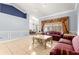 Open living room with adjacent dining area, tiled floor and decorative trim at 3621 Sw 52Nd Ter, Ocala, FL 34474