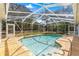 Screened in pool area with an attached waterfall and a relaxing atmosphere at 3621 Sw 52Nd Ter, Ocala, FL 34474