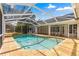 Enclosed pool area with a brick surround and a screen enclosure that is perfect for relaxing at 3621 Sw 52Nd Ter, Ocala, FL 34474