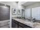 Elegant bathroom featuring double sinks with granite countertops and stylish gray tile in shower at 4250 Sw 53Rd Lane Rd, Ocala, FL 34474