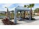 Relaxing poolside cabana with lounge chairs, curtains, and beautiful landscaping in a well-maintained community at 4250 Sw 53Rd Lane Rd, Ocala, FL 34474