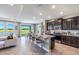 Open-concept kitchen with granite countertops, stainless steel appliances, and a large island overlooking the water view at 4250 Sw 53Rd Lane Rd, Ocala, FL 34474