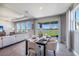 Open-concept living and dining area with contemporary decor, a water view, and large windows for ample natural light at 4250 Sw 53Rd Lane Rd, Ocala, FL 34474