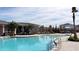 A sparkling swimming pool is situated near a community clubhouse, with lounge seating and a cabana at 4250 Sw 53Rd Lane Rd, Ocala, FL 34474