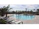 A resort-style pool features cabanas and lounge chairs for relaxing in a community surrounded by palm trees at 4250 Sw 53Rd Lane Rd, Ocala, FL 34474